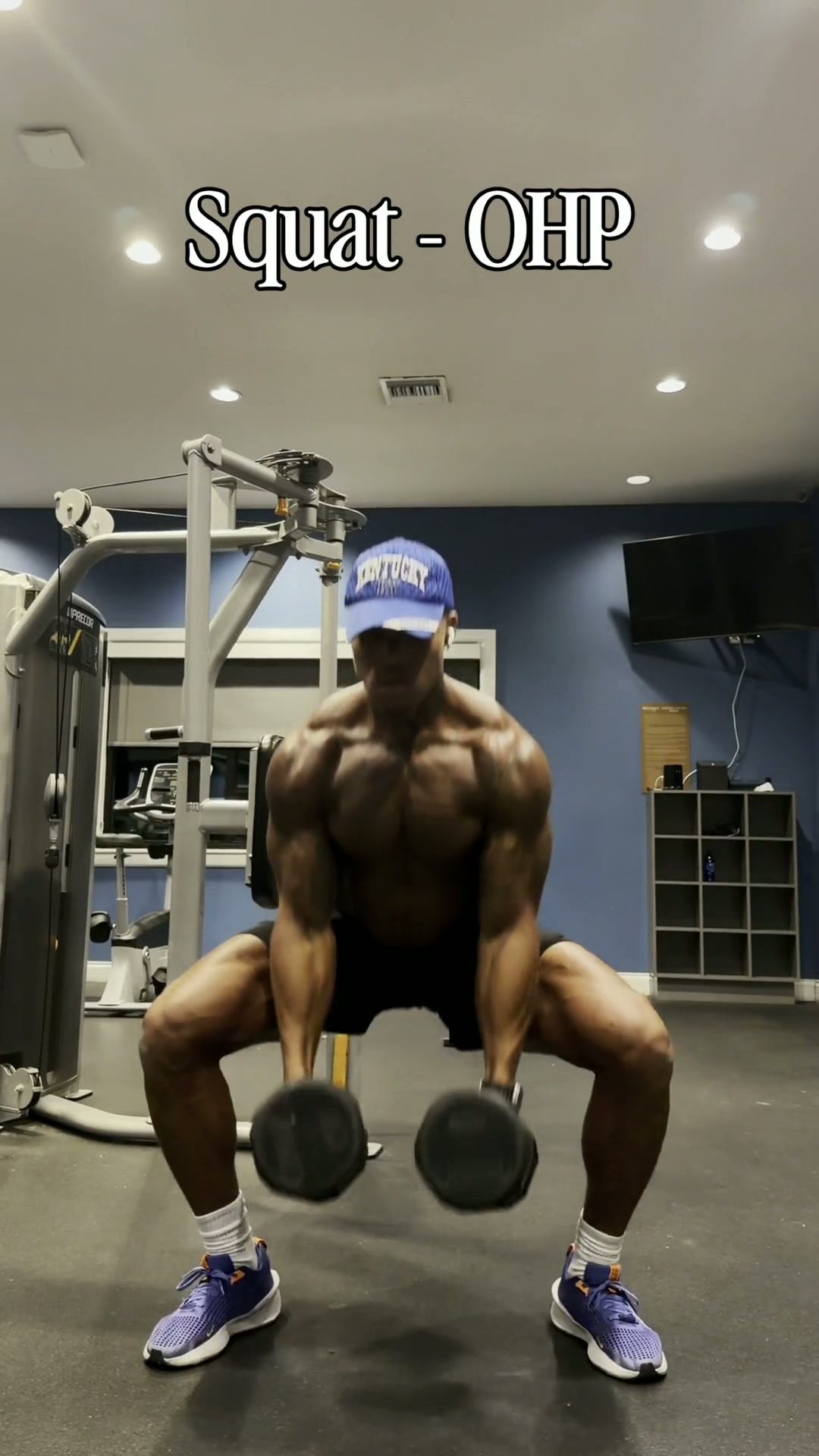 Coach Mac demonstrating a squat and overhead press circuit